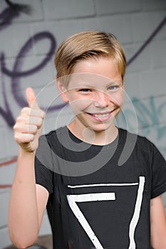 Happy schoolboy with thumb up