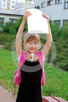 Happy schoolgirl with graduation certificate