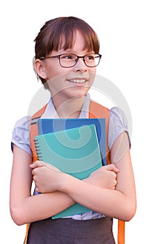 Happy schoolgirl isolated on white background. Portrait of adorable child with backpack and notebooks
