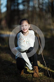 Happy schoolgirl`s portrait in the spring park