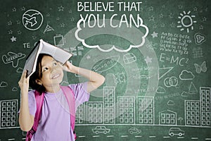 Happy schoolgirl with text of believe that you can