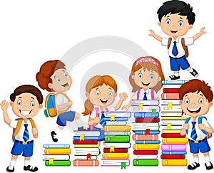 Happy schoolkids playing with stack of books