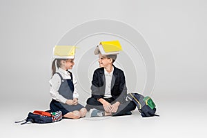 happy schoolkids in uniform with books