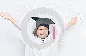Happy scientist girl wear graduation hat.