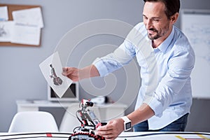 Happy scientist holding a prototype of his invention