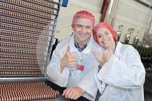 Happy scientists in factory