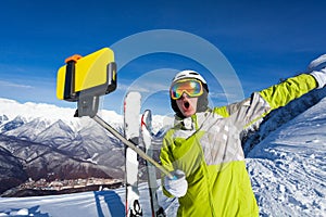 Happy screaming skier take photo with camera