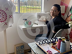 Happy seamstress in studio