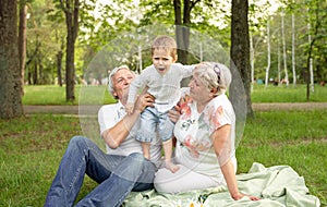 Happy senior adult couple having weekends with their grandchild