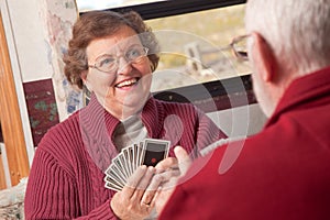 Happy Senior Adult Couple Playing Cards