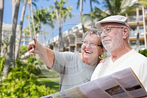 Happy Senior Adult Couple Tourists with Brochure