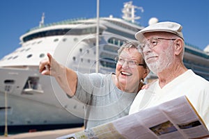 Happy Senior Adult Couple Tourists with Brochure by Cruise Ship