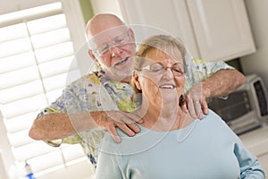 Senior Adult Husband Giving Wife a Shoulder Rub photo