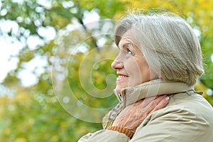 Happy senior beautiful woman in autumnal park