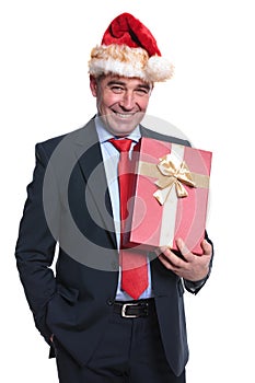Happy senior business man holding a big present box