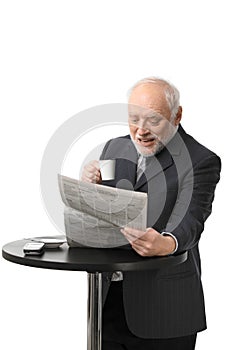 Happy senior businessman reading newspaper