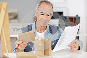 Happy senior carpenter at work photo