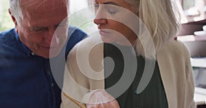 Happy senior caucasian couple at home in the kitchen