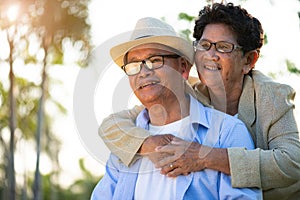 A happy senior couple asian old man and woman smiling and laughing in the garden, happy marriage. Senior healthcare and