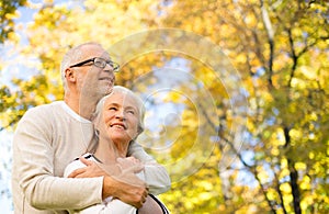 Happy senior couple in autumn park