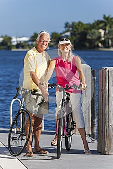 Happy Senior Couple on Bicycles By a River