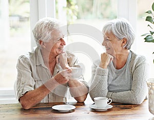 Happy senior couple, coffee and smile for morning breakfast, relationship or bonding together at home. Elderly man and