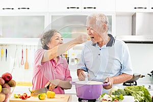 Senior couple cooking in kitchen