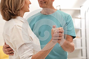 Happy senior couple dancing at home