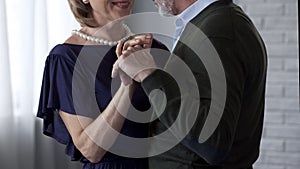 Happy senior couple dancing, looking at each other and smiling, anniversary