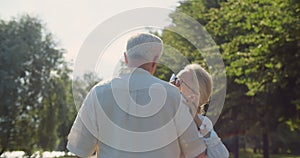 Happy senior couple dancing in summer park