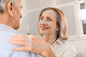 Happy senior couple dancing together at home