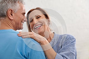 Happy senior couple dancing together at home