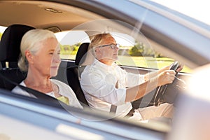 Happy senior couple driving in car