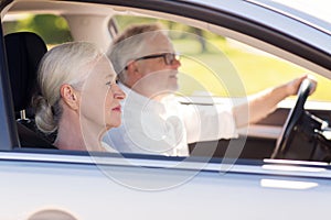 Happy senior couple driving in car