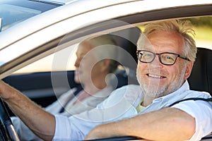 Happy senior couple driving in car