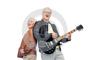 Happy senior couple with electric guitar singing