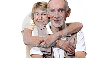 Happy senior couple embracing on white