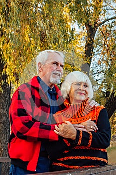 Happy senior couple enjoying each other in the park. Support and care from a loved one, warm emotions