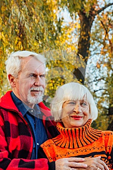 Happy senior couple enjoying each other in the park. Support and care from a loved one, warm emotions