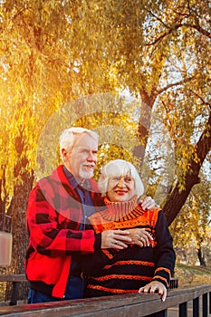 Happy senior couple enjoying each other in the park. Support and care from a loved one, warm emotions