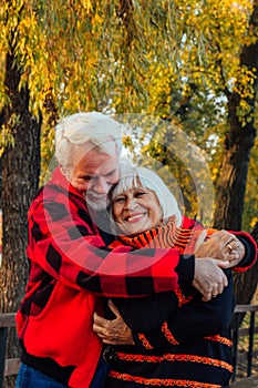 Happy senior couple enjoying each other in the park. Support and care from a loved one, warm emotions