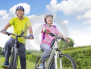 Happy  senior couple exercising with bicycles