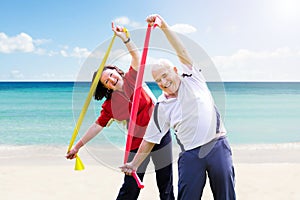 Happy Senior Couple Exercising With Yoga Belt