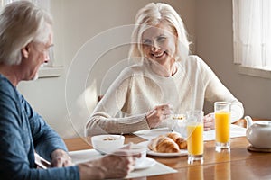 Happy senior couple have healthy breakfast at home