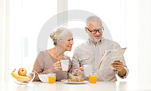 Happy senior couple having breakfast at home