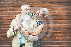 Happy senior couple having fun outdoor - Mature people laughing and having tender moments - Love, fashion and joyful elderly