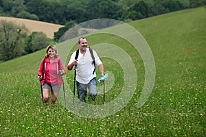 Happy senior couple hiking in countryside