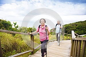 Happy senior couple hiking on the mountain park