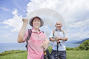 Happy Senior couple hiking together on the mountain and coast