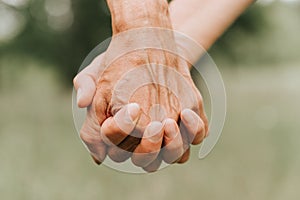 Happy senior couple holding hands. hands of man and woman hold each other. romance and love and support in elderly family. faceles